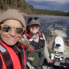 Elina Kasvi and Linnea Blåfield driving a research boat at a Finnish river