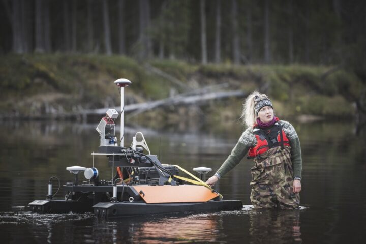 Researcher Linnea Blåfield with the Otter USV, photo Ville Kankare